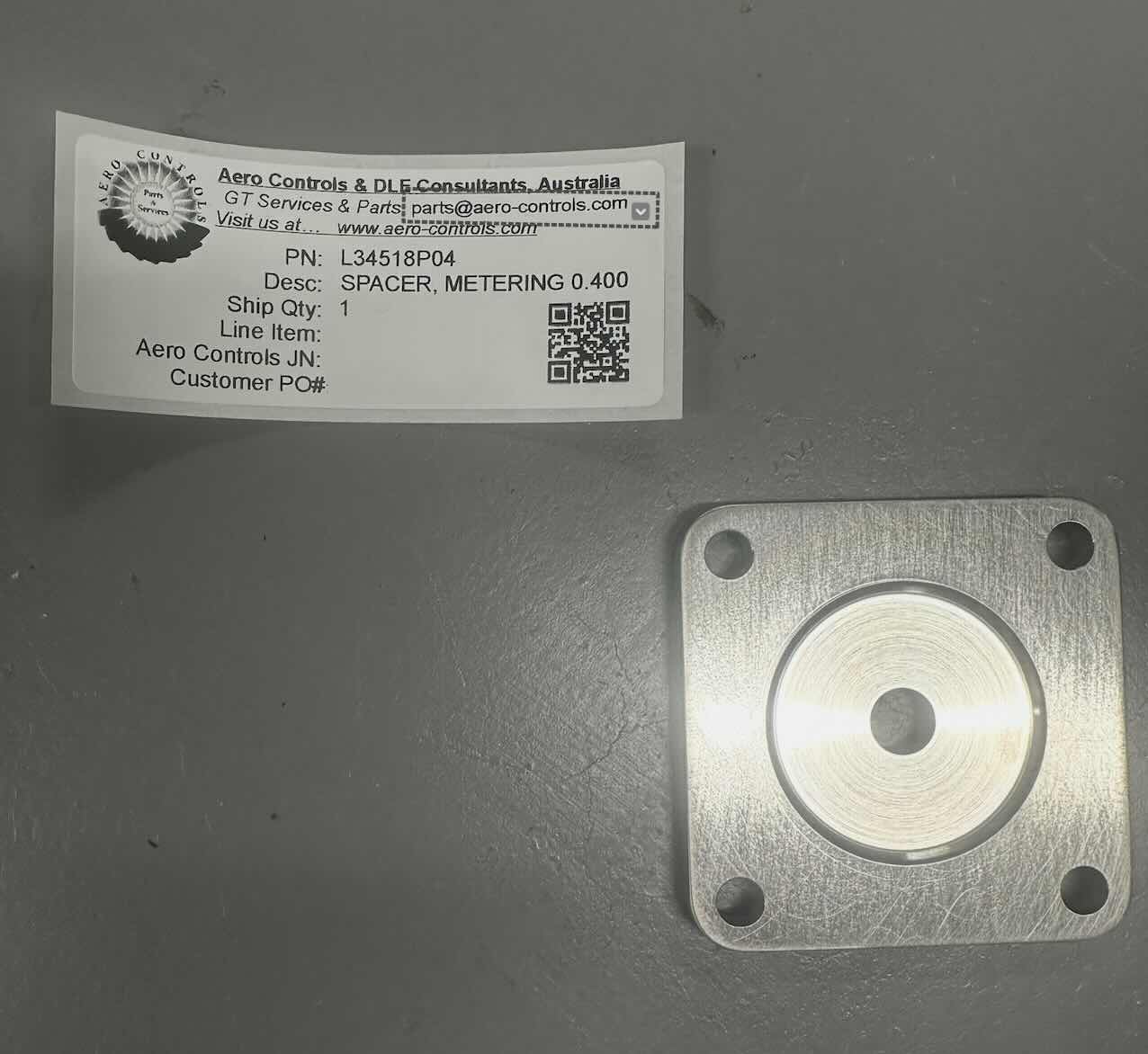L34518P04 SPACER, METERING, 0.400 ORIFICE DIAMETER