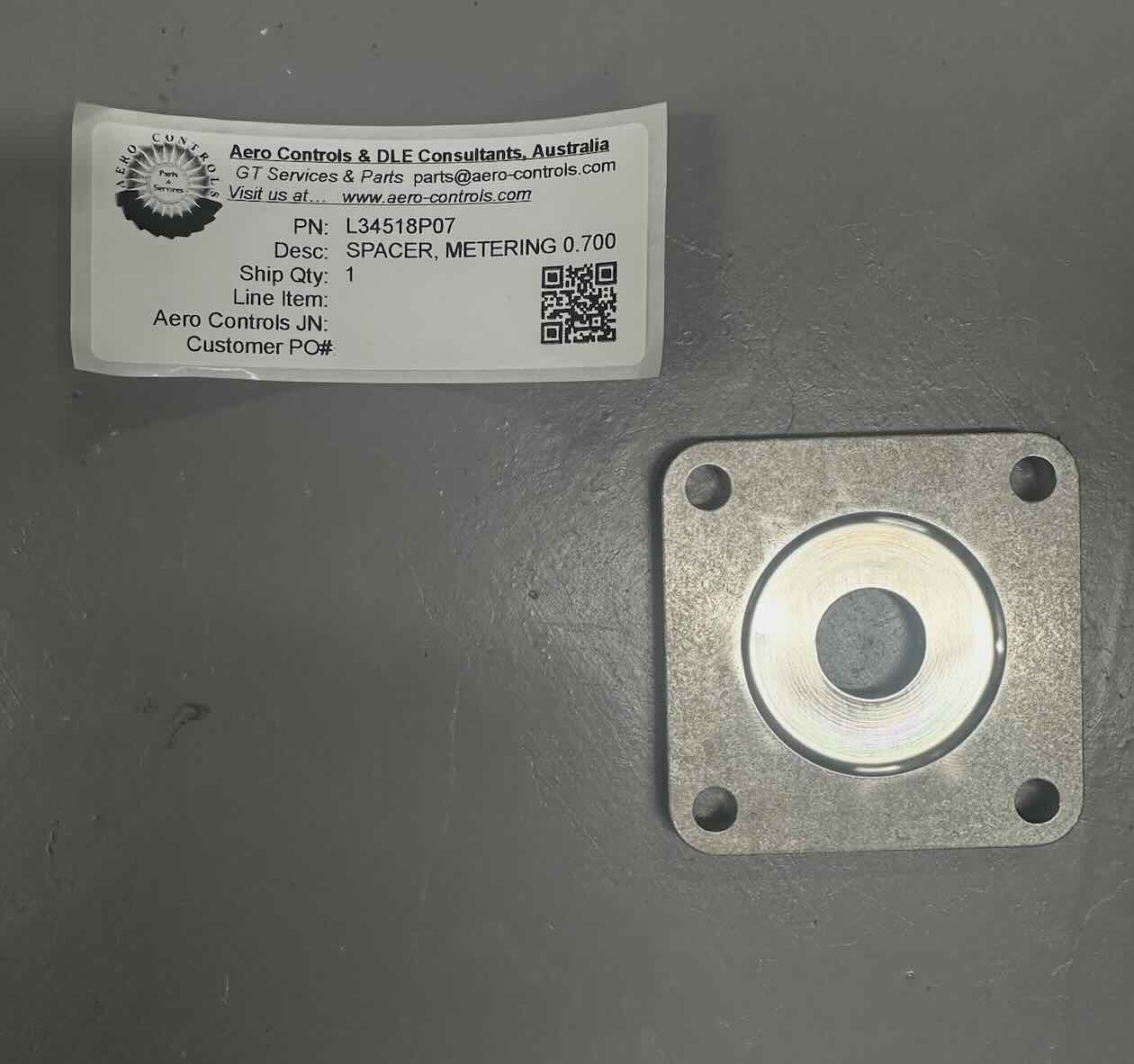 L34518P07 SPACER, METERING, 0.700 ORIFICE DIAMETER